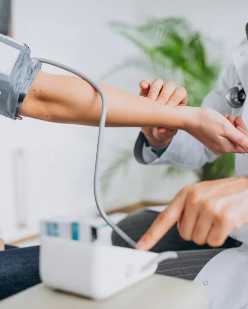 young-male-psysician-with-patient-measuring-blood-pressure-3-scaled